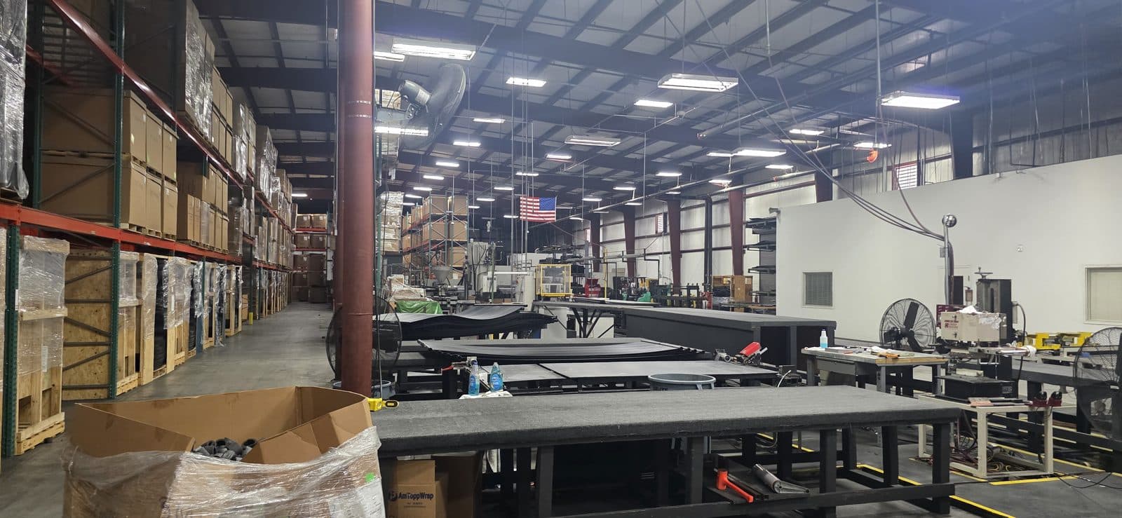 The Aquonyx production floor: assembly benches, racked inventory and the American flag